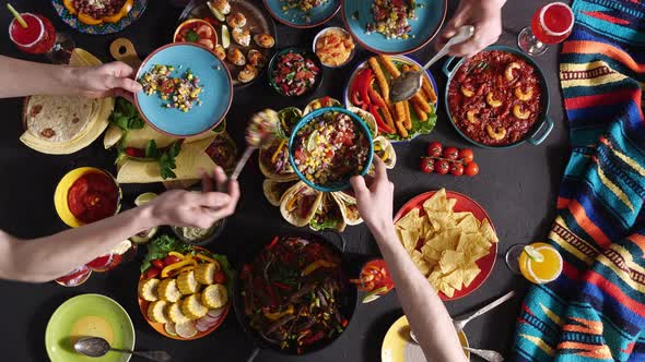 Hispanic Friends Eating Traditional Food at a Restaurant