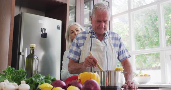 Happy senior caucasian couple at home in the kitchen