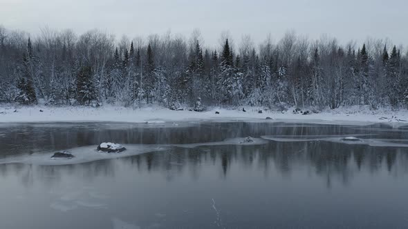 Lake shoreline frozen lake Winter wonderland aerial