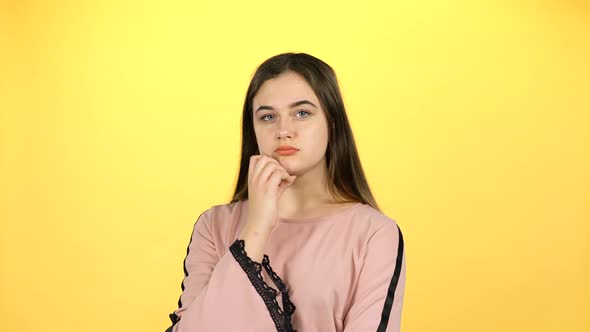 Teenage Girl Showing Emotion on Yellow Background