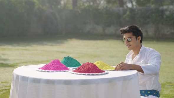 Indian man looking at the Holi colors