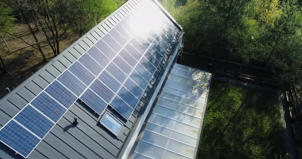 Orbiting around modern house with solar panels on roof.