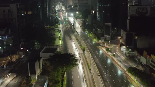 Low Flying Aerial Dolly Shot Flying Above Empty Multi Lane Highway Through Urban City Center with