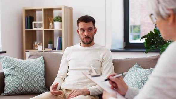 Senior Woman Psychologist and Sad Man Patient