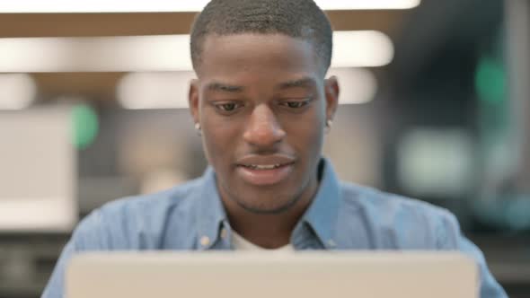 Young African American Man Talking on Video Call on Laptop