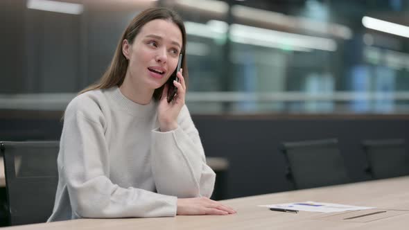 Woman Talking on Phone at Work