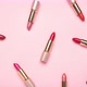 Pink lipsticks moving on pink background - Stop motion. - VideoHive Item for Sale