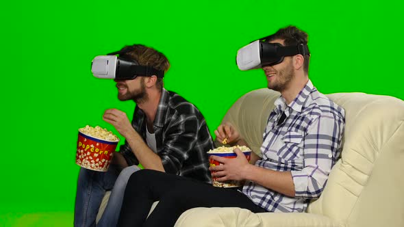 Men Watch a Movie in VR Masks. Green Screen