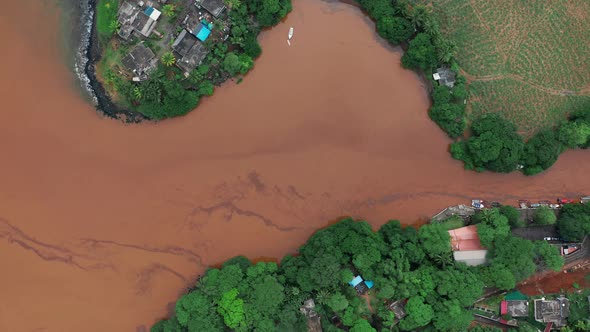 Floods in the Streams Wide Dirty River with Muddy Orange Water and Fields Flooded Pastures