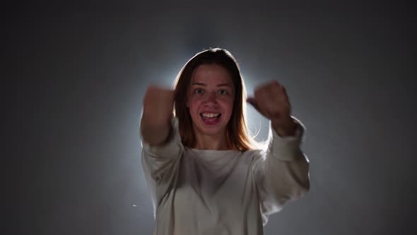 Talented Woman Dancing Hip Hop on Background with White Light in Studio