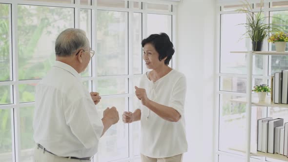 Family concept. Old Asian couple dancing merrily at home. 4k Resolution