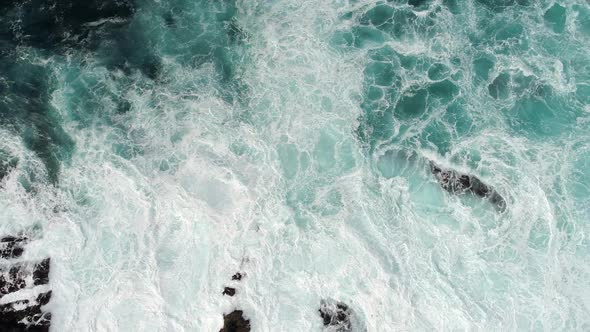 Fierce Stormy Waves, Covered with Foam, Striking the Rocky Coast with Great Power