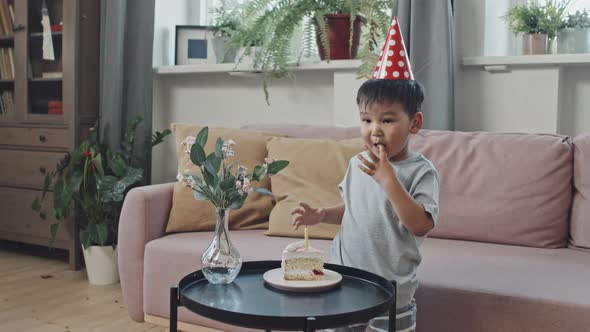 Asian Boy Eating Birthday Cake