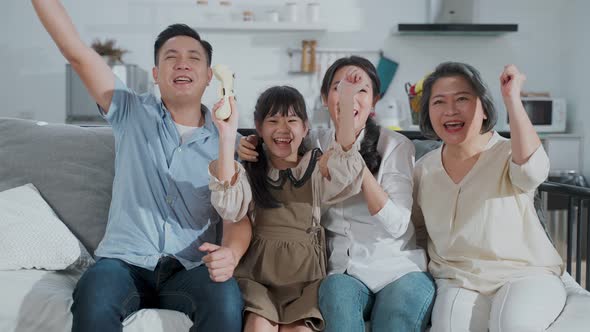 Portrait of Asian happy family sitting and looking at camera with smile together at home together.