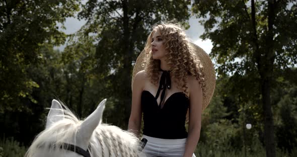 Young Rider Walks In Nature Riding A White Horse
