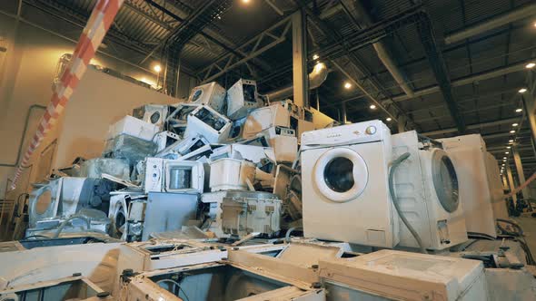 Old Washing Machines Piles at Recycling Center. Plastic Trash at Garbage Recycling Factory.