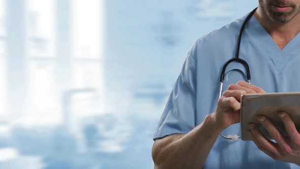 Mid section of male health worker using digital tablet against hospital in background