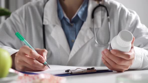 Employee Doctor Writes Information In A Notepad On A Piece Of Paper Rewriting Important Information