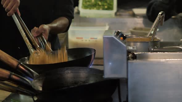 Chef is Stirring Vegetables in Wok Noodles Fire Flambe Asia Kitchen Chinesse Pan Pasta Seafood