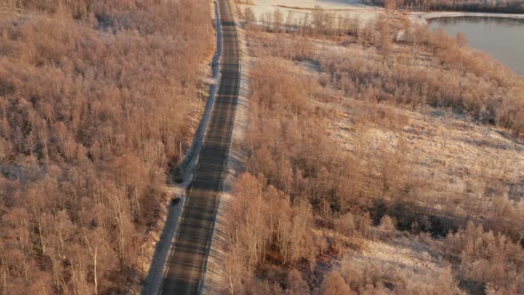 Drone Tracking Car On Road Through Forest