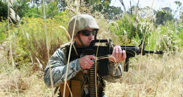 Military soldier guarding with a rifle alt