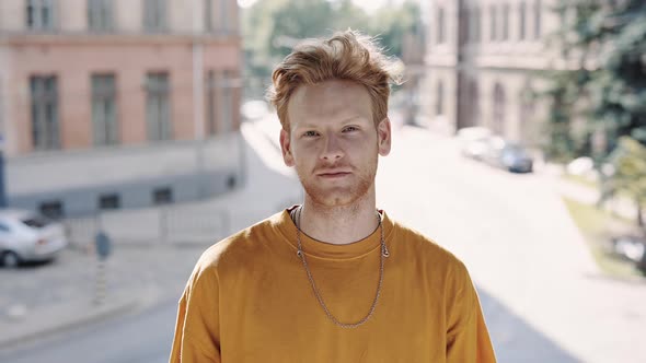 Portrait of Handsome Red Hair Guy Standing on City Street