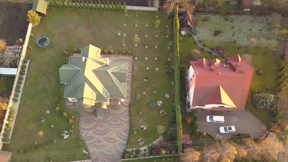 Aerial landscape of small town or village with rows of residential homes and green trees.