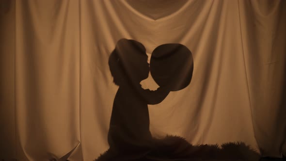 Silhouette of Little Boy Wearing Cowboy Hat and Holding Toy Gun