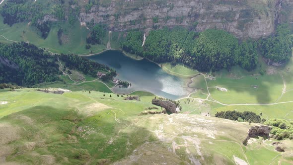 Flying over Seealpsee lake in the Alpstein range, Appenzell Alps, Switzerland