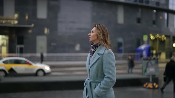 Lonely Adult Lady is Walking on City Street in Rainy Day Strolling in Downtown