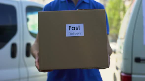 Fast Delivery Service Courier in Uniform Holding Cardboard Box, Express Shipping