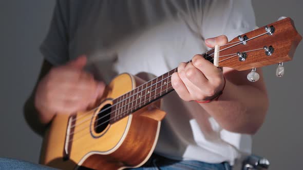 Close-up of Female Hands Playing on Ukulele