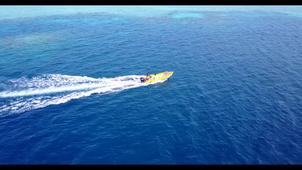 Aerial top view scenery of tranquil bay beach voyage by transparent water with white sandy backgroun