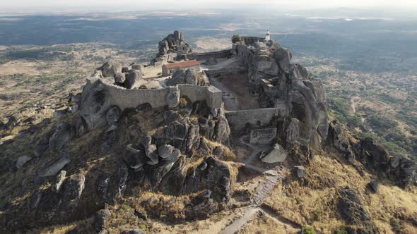 Castle of Monsanto, ruins of 12th century hilltop medieval castle. Orbiting wide shot