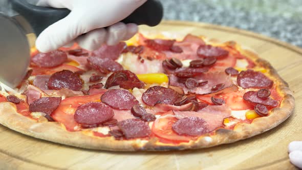 Chef Cutting Pizza Close Up.