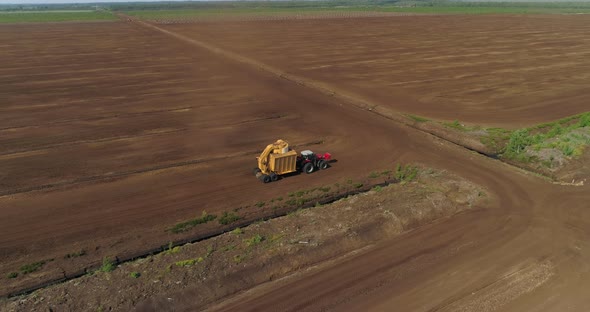 Peat Harvesting Machinery Extracting Turf in Drained Bog Aerial View