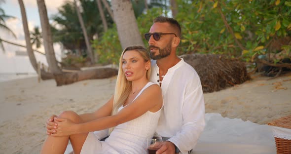 Couple of Lovers Have Rest on Evening Beach Admiring Ocean and Drinking Red Wine Great Time Together