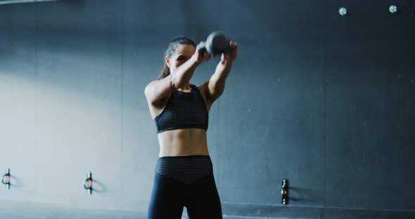 Woman Exercising with Kettlebells