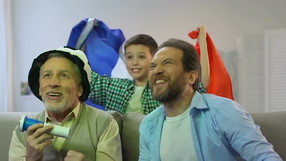 Family Watching Football Game at Home, Boy With French Flag Cheering for Victory
