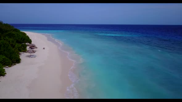 Aerial flying over travel of perfect island beach adventure by blue green water and white sandy back