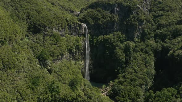 AERIAL: Waterfall in the mountains in Madeira