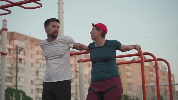 Fit Couple Making Stretching Before Running Workout