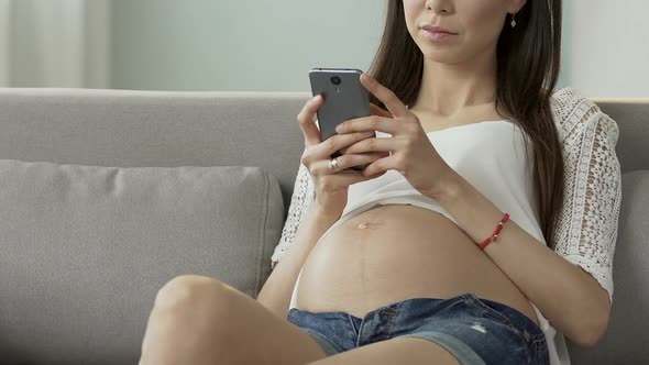 Expecting Lady Typing Message on Mobile Phone, Smiling, Socializing With Friends