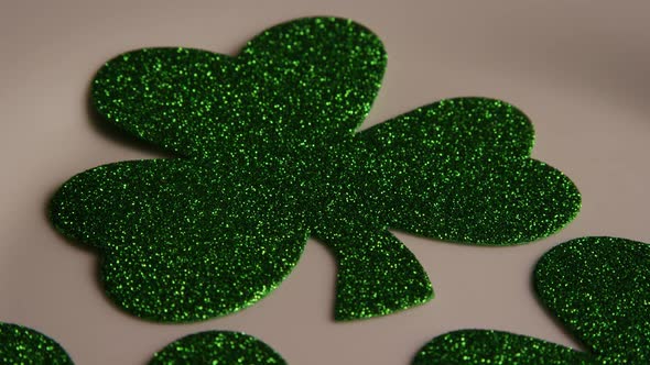 Rotating stock footage shot of St Patty's Day clovers on a white surface - ST PATTYS 009