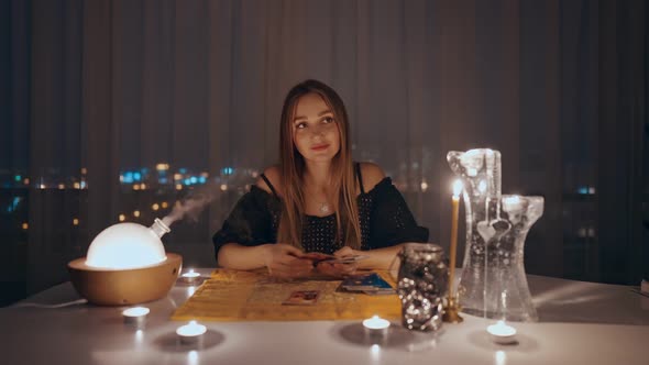 Woman Reading Tarot Cards in Spiritual Room