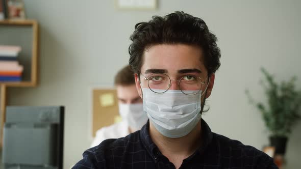 Portrait of Serious Spain Worker Man Wearing Circle Glasses and Medical Mask