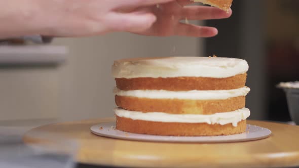 The Pastry Chef Puts the Fourth and Last Layer of Sponge Cake