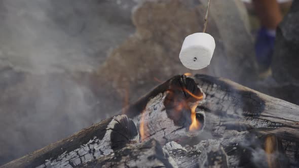 Closeup of marshmallows roasting on campfire