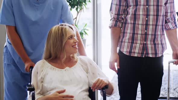 Male doctor interacting with pregnant woman