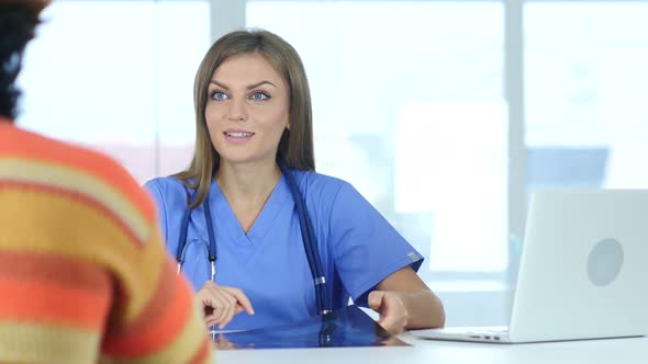 Positive Female Doctor Talking with Patient